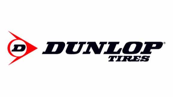 Dunlop Tires logo featuring bold black lettering and red triangular emblem.