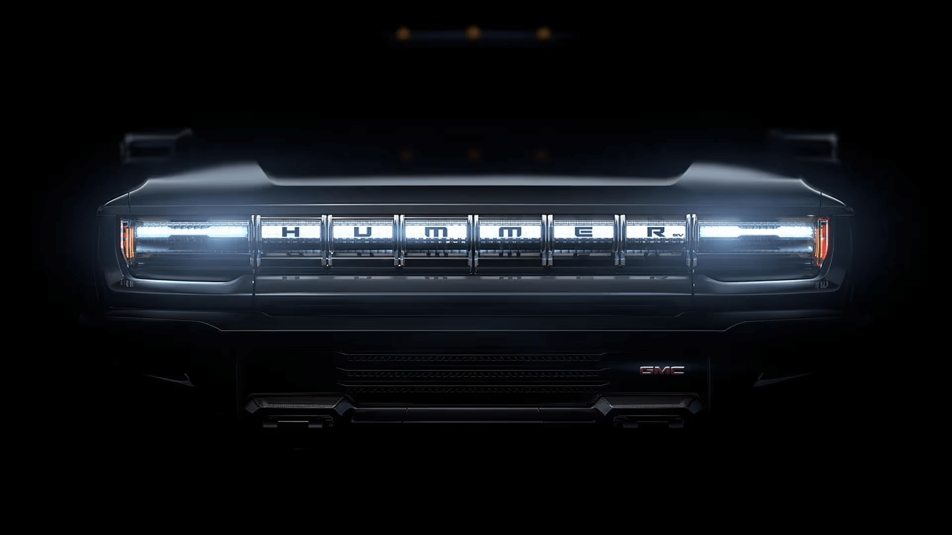 Front view of an illuminated Hummer EV grille, showcasing sleek design and modern lighting.