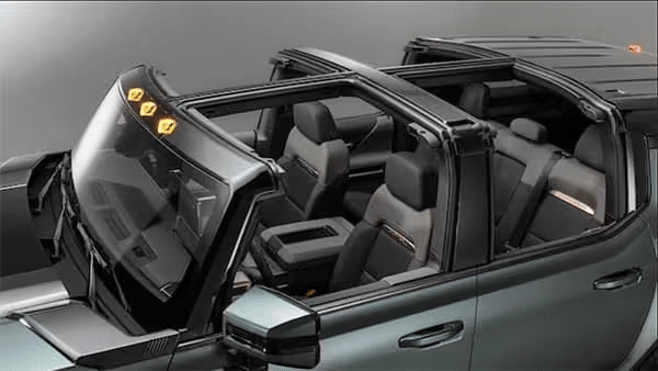 Convertible SUV interior with open roof, showcasing sleek black seating and modern design features.