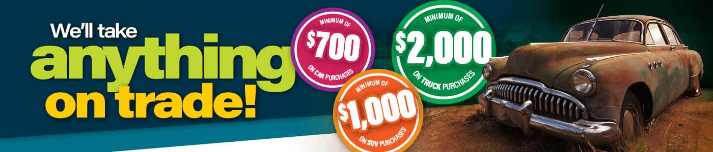 Trade-in offer: Minimum $700 on cars, $1,000 on SUVs, $2,000 on trucks with vintage car shown.