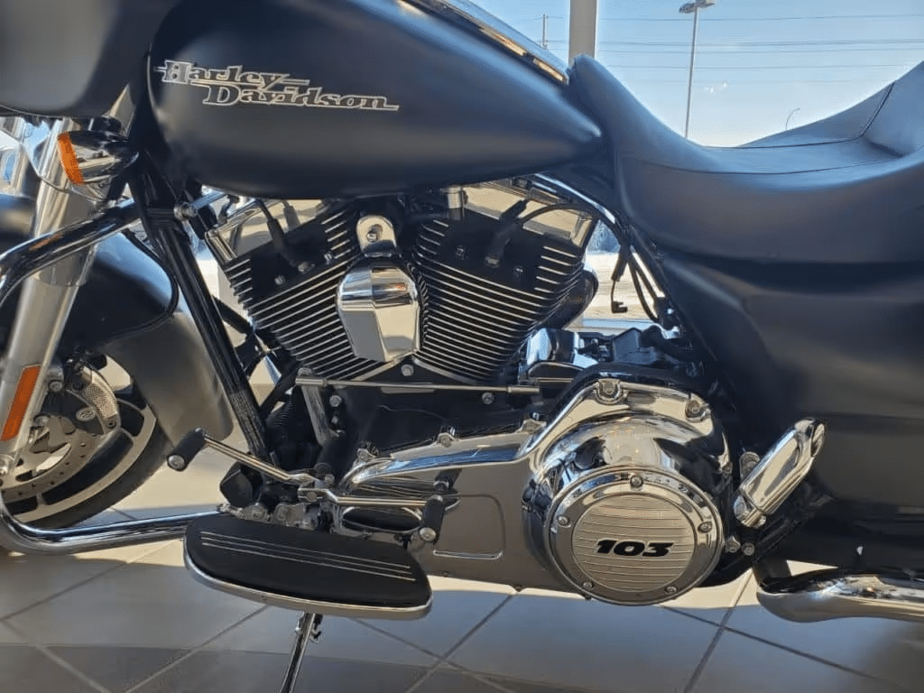 Harley-Davidson motorcycle engine close-up with chrome details and 103 inscription.