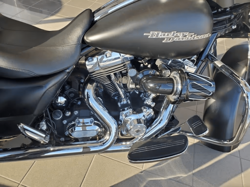 Close-up of a black Harley-Davidson motorcycle, showcasing the engine and sleek design.