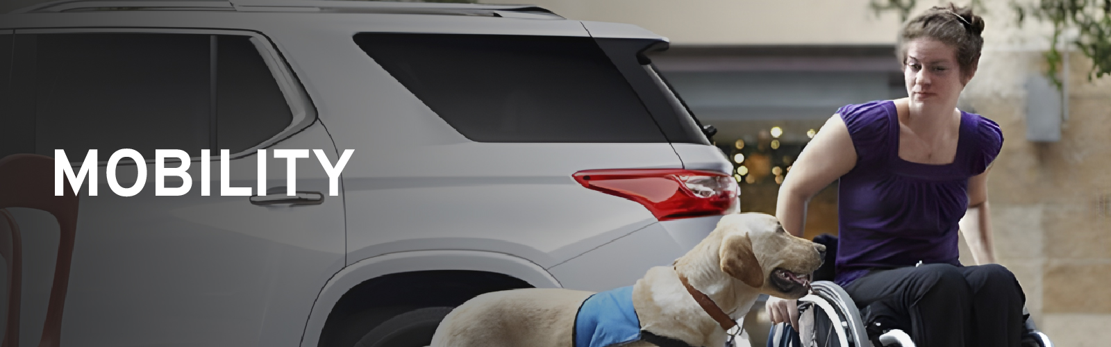 Woman in wheelchair with service dog next to a white SUV, highlighting mobility.