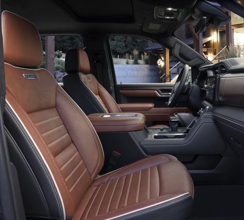 Luxurious truck interior featuring brown leather seats and a modern dashboard design.