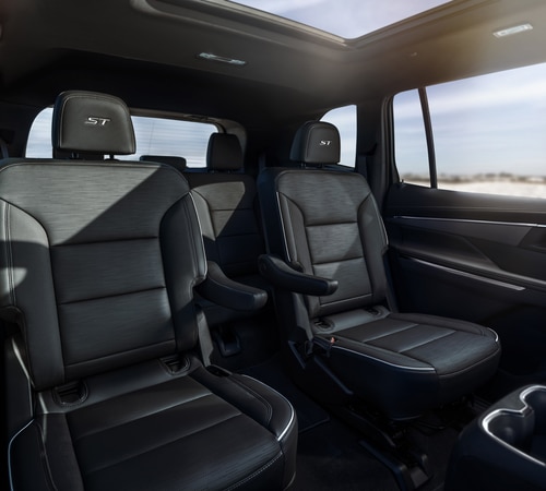 Spacious black leather interior of a modern SUV with captain's chairs and ST branding.