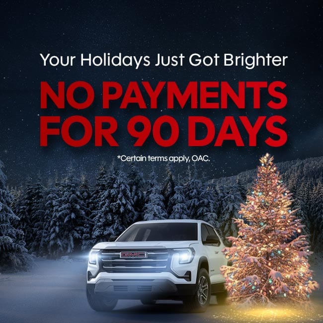 White GMC vehicle next to a lit Christmas tree with "No Payments for 90 Days" holiday offer.